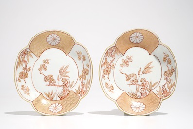 A pair of Chinese milk and blood quatrefoil cups and saucers, Kangxi