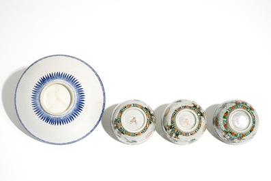 Three Chinese famille verte crackle glaze cups and saucers and a blue and white soft paste bowl, Kangxi