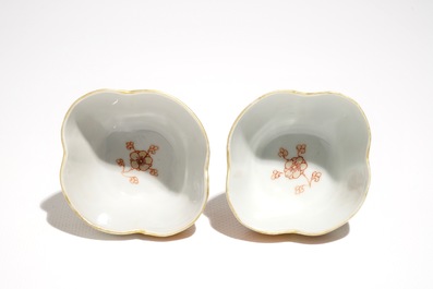 A pair of Chinese milk and blood quatrefoil cups and saucers, Kangxi