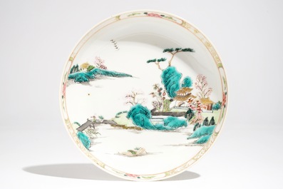 Une tasse et soucoupe en porcelaine de Chine famille rose &agrave; d&eacute;cor d'un paysage, Yongzheng/Qianlong