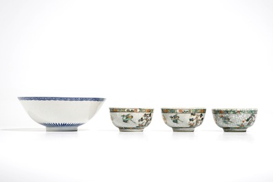 Three Chinese famille verte crackle glaze cups and saucers and a blue and white soft paste bowl, Kangxi