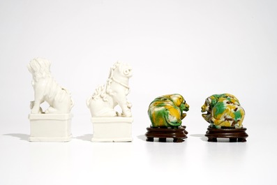 A pair of Chinese Dehua blanc de Chine Buddhist lion joss stick holders and a pair of verte biscuit dogs, Kangxi