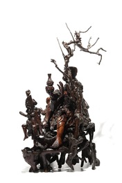 A large Chinese carved root wood group with a Luohan, 19th C.
