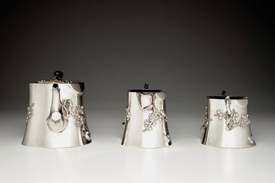 A Chinese silver teapot, milk jug and sugar bowl, Luen Wo, 1880-1940