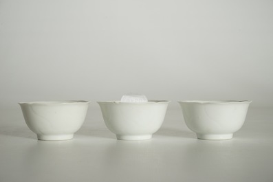 Three blanc de Chine cups and saucers with floral anhua design, Yongzheng/Qianlong