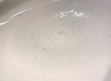 A Chinese Dehua blanc de Chine dish with incised floral design, Kangxi