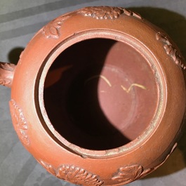Een Chinese Yixing steengoed theepot met reli&euml;fdecor, Kangxi