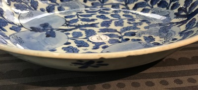 A Chinese blue and white dish with sanduo fruits among foliage, Kangxi