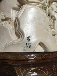 Twee Chinese ivoren groepjes op houten sokkel, 2e kwart 20e eeuw