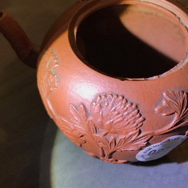 Een Chinese Yixing steengoed theepot met reli&euml;fdecor, Kangxi