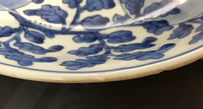 A Chinese blue and white dish with sanduo fruits among foliage, Kangxi