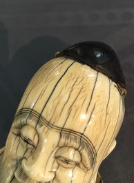 A Chinese ivory figure of the immortal Han Zhongli, on wooden base, late Ming