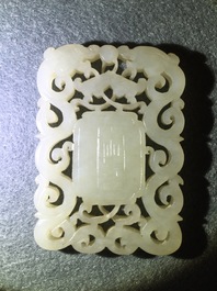 A Chinese white jade plaque with dragons and Taoist symbols, 19th C.