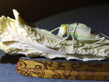 A Chinese polychrome ivory group of a cricket on cabbage, early 20th C.