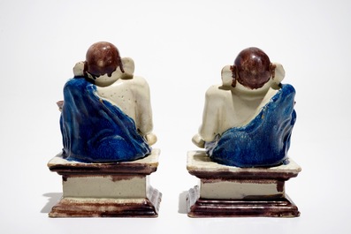 A pair of German faience models of Buddhas in Delft style, 1st half 18th C.