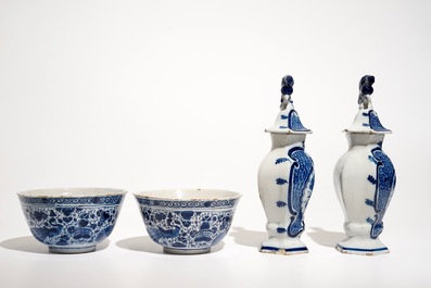 A pair of Dutch Delft blue and white bowls and a pair of vases and covers, 18th C.