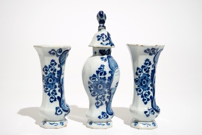 A Dutch Delft blue and white three-piece garniture with a naval scene, 18th C.