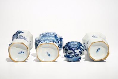 A Dutch Delft blue and white three-piece garniture with a naval scene, 18th C.