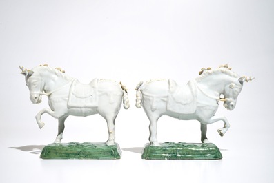 A pair of white Dutch Delft circus horses on a green base, 18th C.