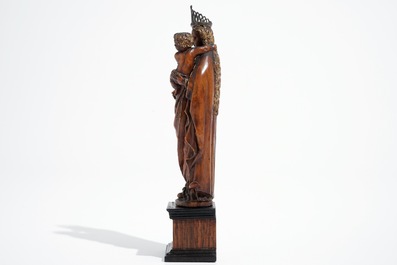 A carved and partial gilt boxwood Madonna with child on rosewood base, 16/17th C.