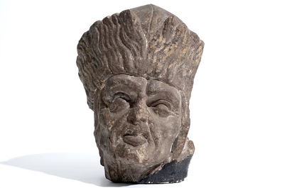 A Flemish carved stone bishop's head, 15/16th C.