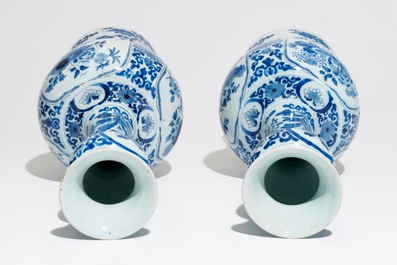 A pair of tall Dutch Delft blue and white chinoiserie vases, 1st half 18th C.