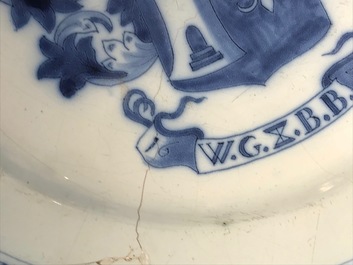 A Dutch Delft blue and white armorial dish dated 1683 and a blue and white landscape plate, 17th C.