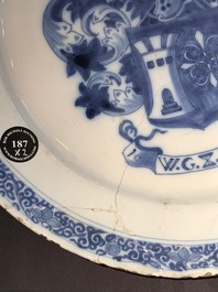 A Dutch Delft blue and white armorial dish dated 1683 and a blue and white landscape plate, 17th C.