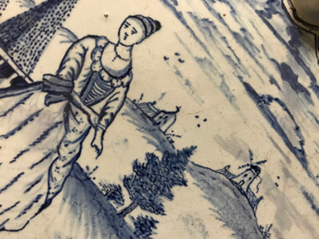 A Dutch Delft blue and white plaque with a lady in a landscape, 18th C.