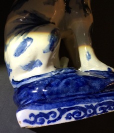 A pair of Dutch Delft blue and white models of dogs, 1st half 18th C.