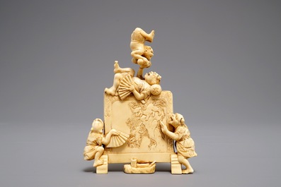 A Japanese carved ivory okimono with oni around a screen, signed, Meiji, 19th C.