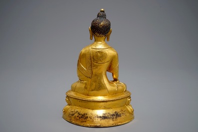 A Tibetan gilt bronze figure of Buddha with vajra, 19th C.