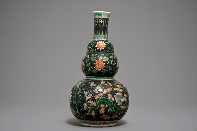 A Chinese black-ground famille verte double gourd dragon vase, 19th C.