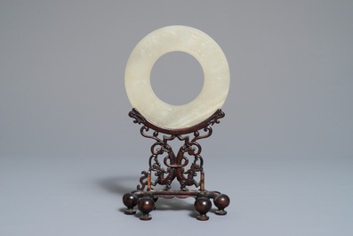 A Chinese pale celadon jade bi disc, Ming or earlier