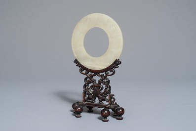 A Chinese pale celadon jade bi disc, Ming or earlier