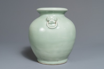 A Chinese monochrome celadon vase with lion head handles, 19th C.