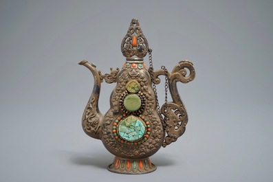A silvered and parcel-gilt brass jug inlaid with turquoise and coral, Tibet or Mongolia, 19th C.