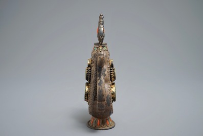 A silvered and parcel-gilt brass jug inlaid with turquoise and coral, Tibet or Mongolia, 19th C.