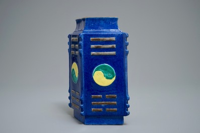 A Chinese blue-ground lozenge-shaped cong vase with taoist symbols, 19th C.