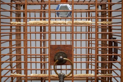 A Chinese wooden bird cage with ivory and porcelain ornaments, 19/20th C.