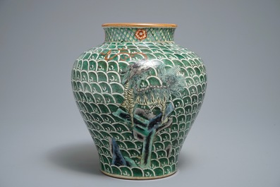 A Chinese famille verte vase with mythical beasts on a ground of waves, 19th C.