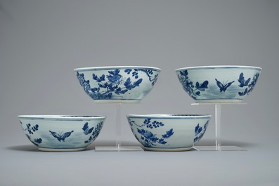 Four Chinese blue and white bowls with birds, butterflies and flowers, 19th C.
