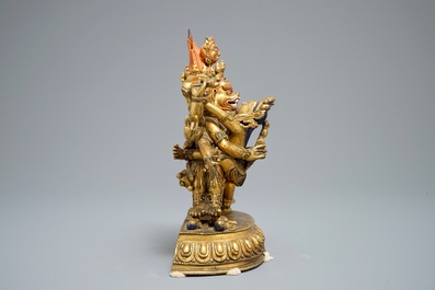 A Sino-Tibetan gilt bronze figure of Mahakala and his consort Yab-Yum, 19/20th C.