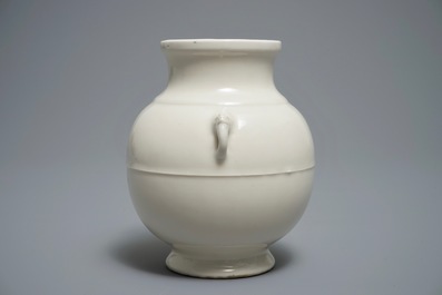 A Chinese cream-glazed hu vase with elephant handles, 18/19th C.