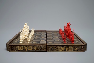 A Chinese lacquered chess and backgammon board with ivory chessmen, 19th C.