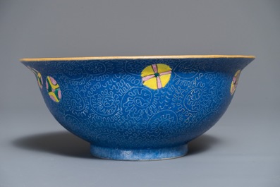 A Chinese famille rose blue ground sgraffiato bowl, Qianlong mark, 19th C.