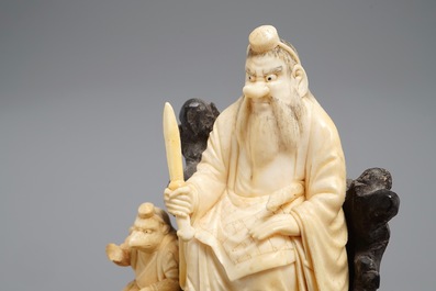 A Japanese carved ivory group on rootwood base, prob. Tokyo school, Meiji, 19th C.
