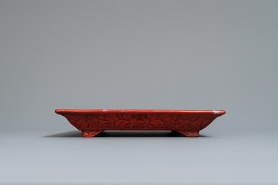 A rectangular Chinese cinnabar lacquer tray with figures in a landscape, 18/19th C.