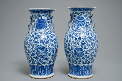 A pair of Chinese blue and white flower scroll vases, 19th C.