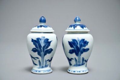 A pair of Chinese blue and white miniature vases and covers or tea caddies, Kangxi